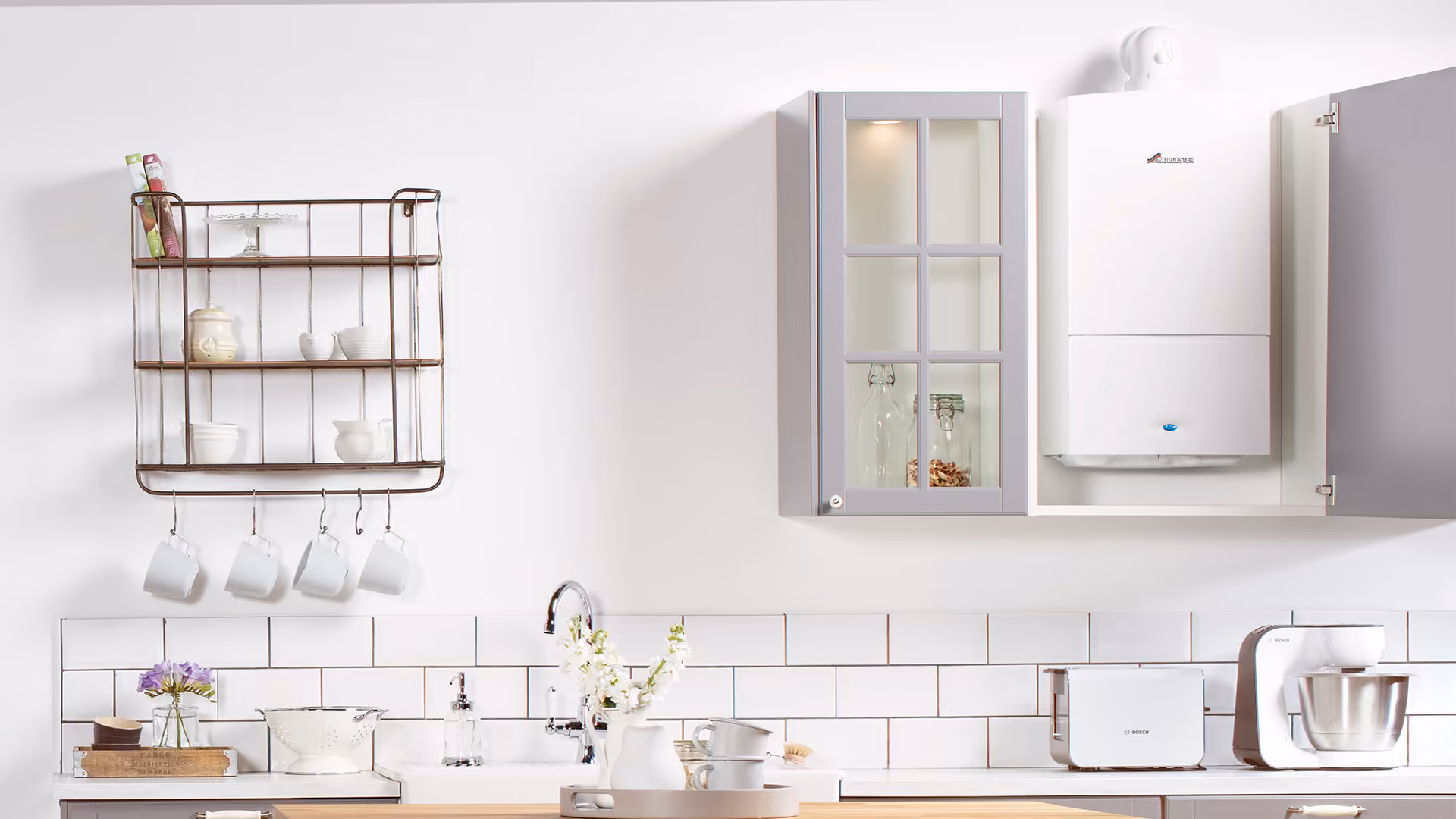 A Worcester Bosch Greenstar CDi Compact boiler fitted inside a kitchen wall cupboard